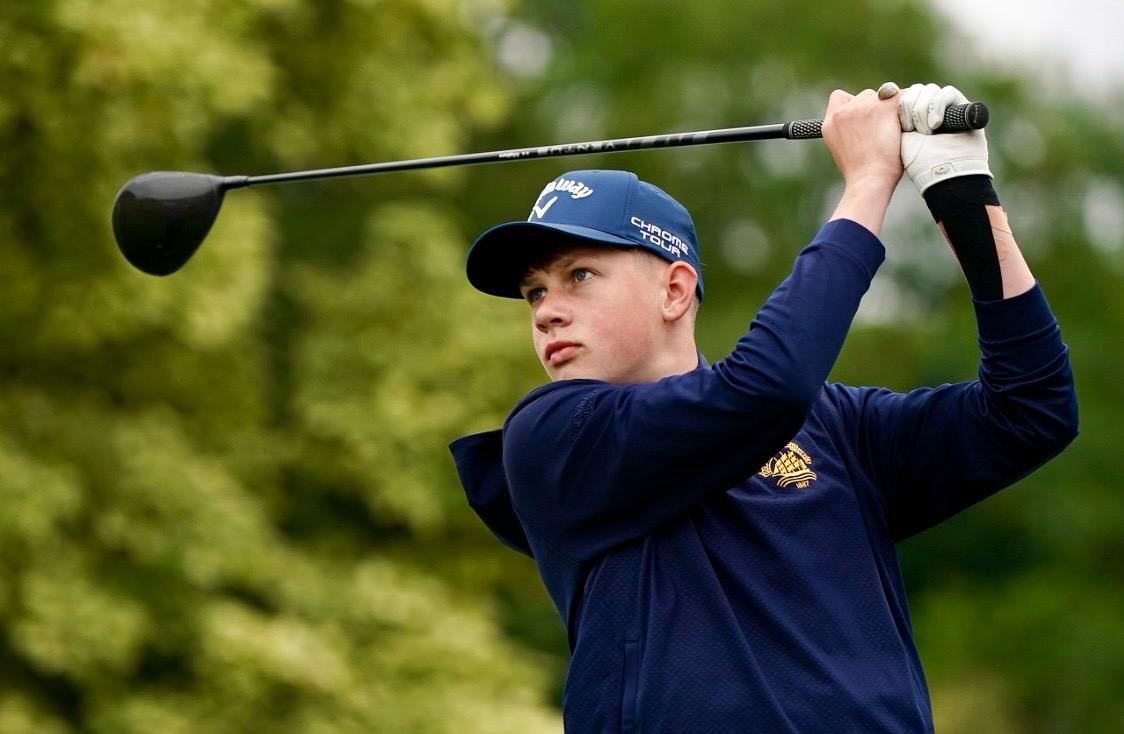 A junior golfer following through on a shot at Cleveland Golf Club